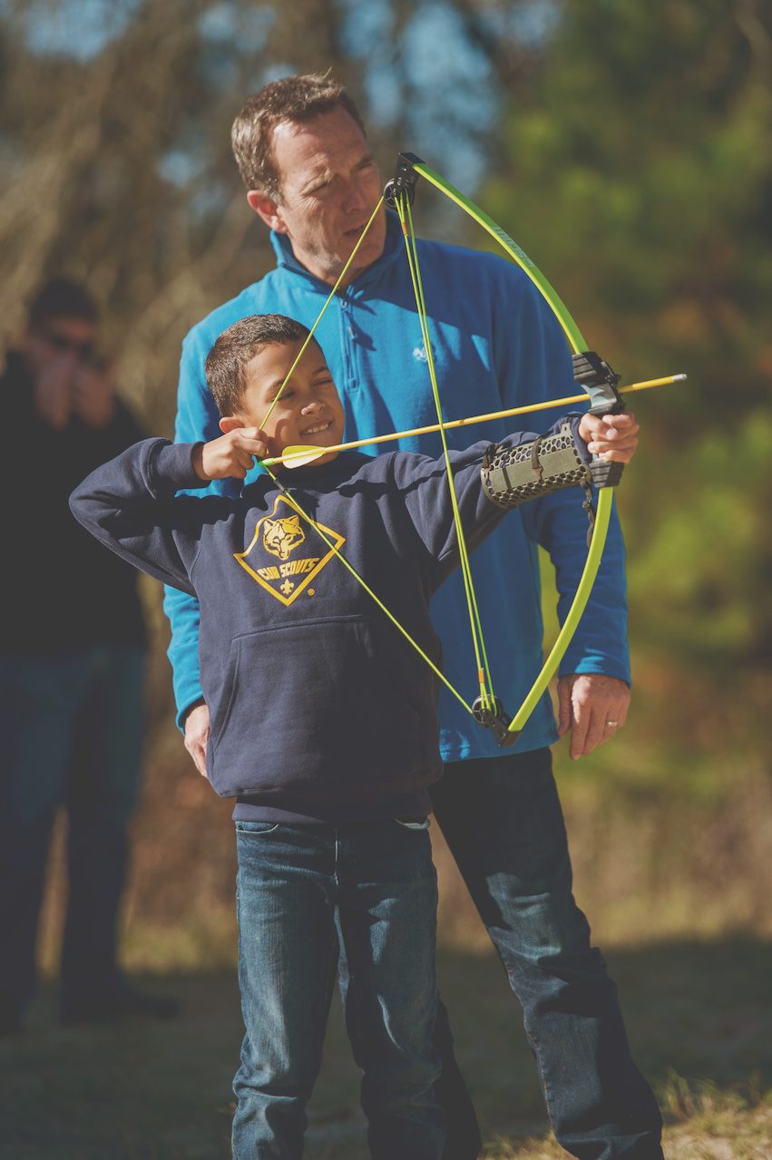 Drawing the bow with a coach behind.
