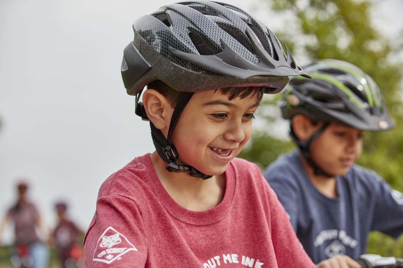 Cubs ride a wooded park trail.