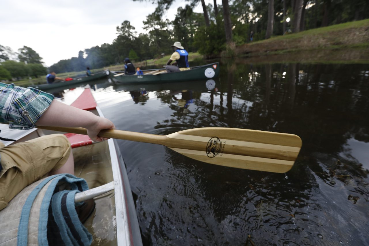 Launching a kayak from shore.