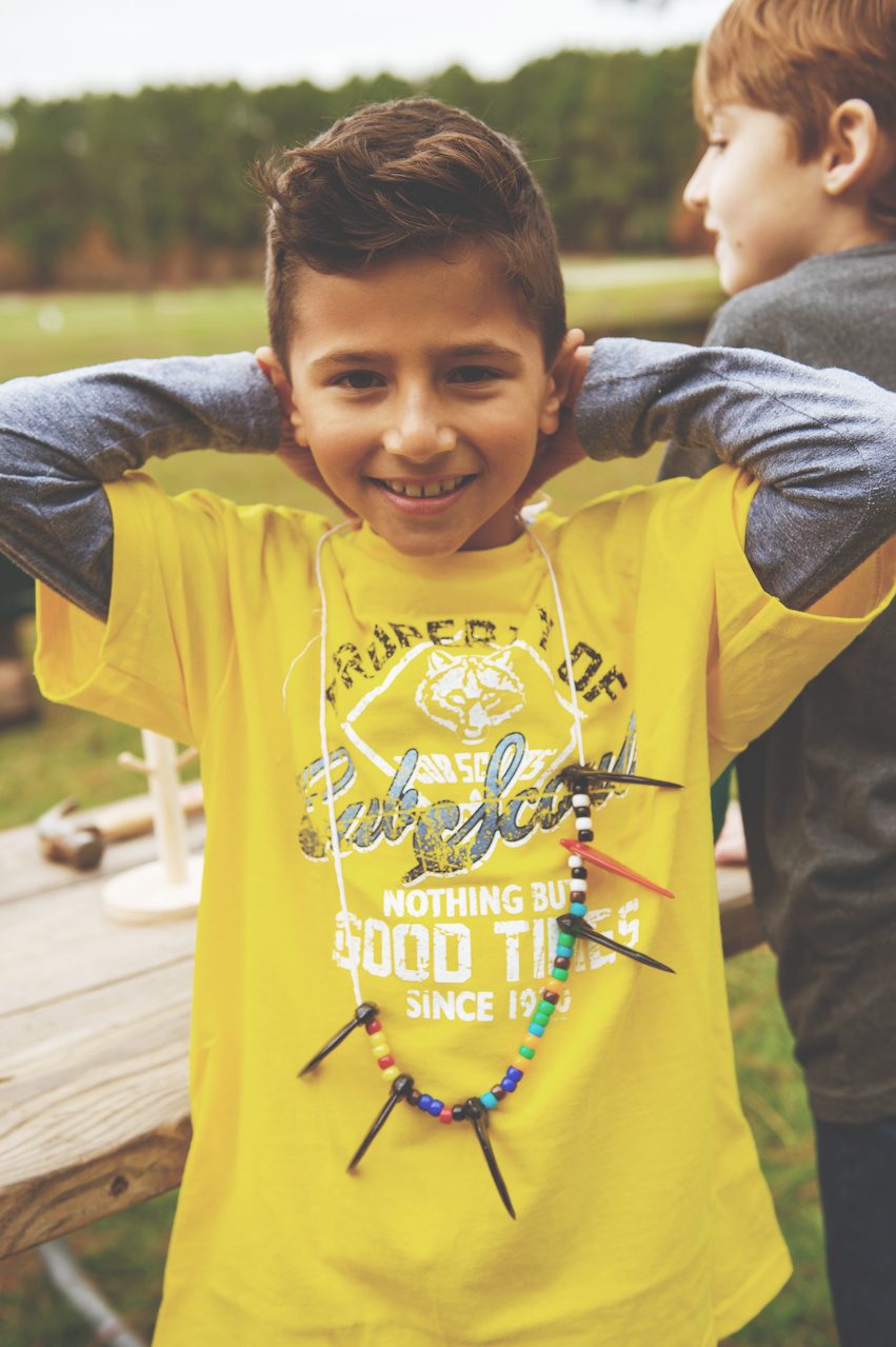 A den leader works alongside a scout.